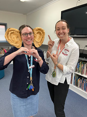 Photo of 2 teachers supporting Big Hearing Days in a school library.