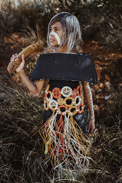 Photo of a student wearing their art piece, the 'Kalkutungu Warrior' described below.